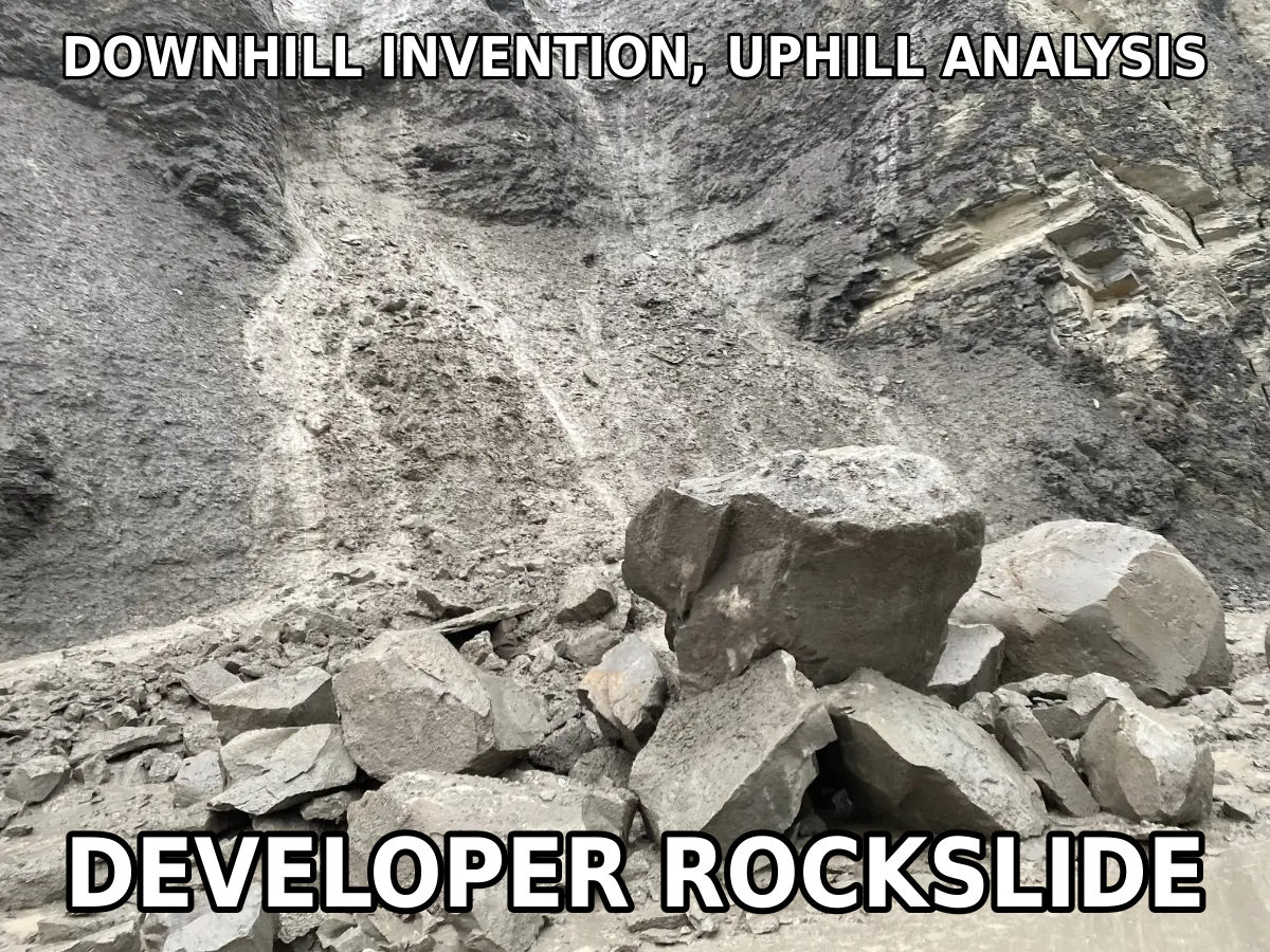 Boulders piled at the foot of a steep gray cliff after a rockslide, with meme text reading “Downhill Invention, Uphill Analysis” on top and “Developer Rockslide” at the bottom. Slippery slopes aren’t always logical fallacies.
